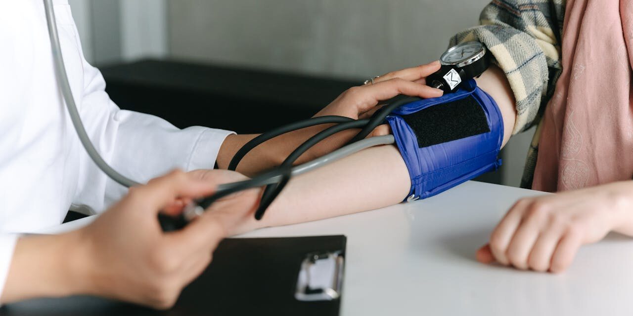 Infirmière prenant la tension artérielle d’un patient.